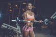 © antondotsenko - Sexy athletic young girl training arms in gym