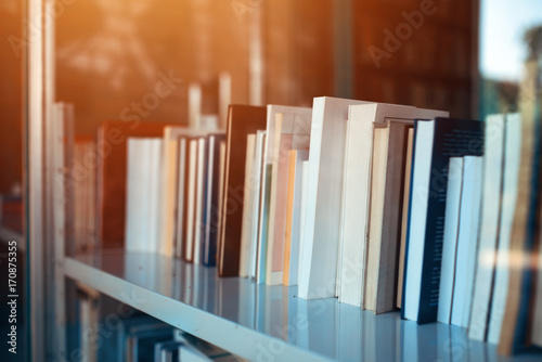 Fotografía Books on library shelf through window