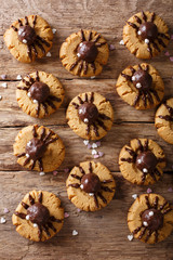 Wall Mural - Homemade Halloween cookies with chocolate spiders close-up. vertical background top view