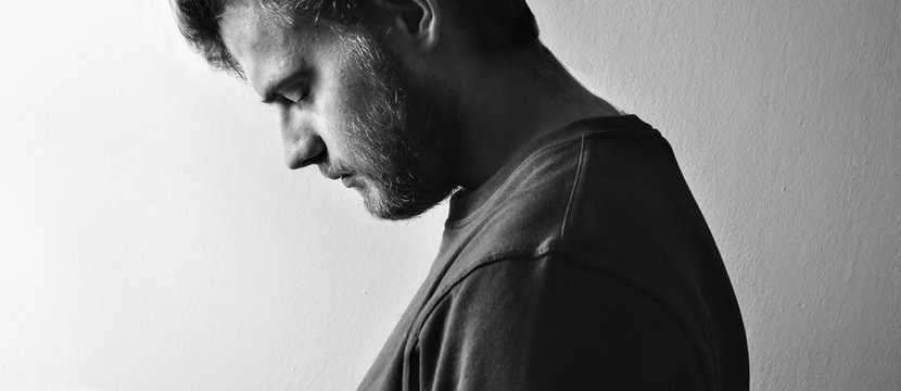 Fototapete - Dark guy, man  profile, tilted his head down in depression on a white background isolated,  black and white