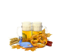 Bavarian soft salted pretzel, wheat ears, sausages, mugs of lager beer, fall yellow maple leaves and blue and white ribbon on a white background with space for text. Oktoberfest