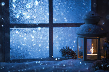 Wall Mural - Winter decoration with a candlestick near the snow-covered window