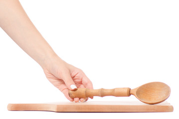 Canvas Print - Female hand holding a cutting boardand and a  wooden spoon 