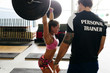 © ADDICTIVE STOCK - Woman with trainer lifting weight