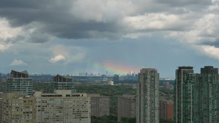 Wall Mural - Time lapse shot of a rainbow passing over the greater Toronto area. Shot from Mississauga, Canada.