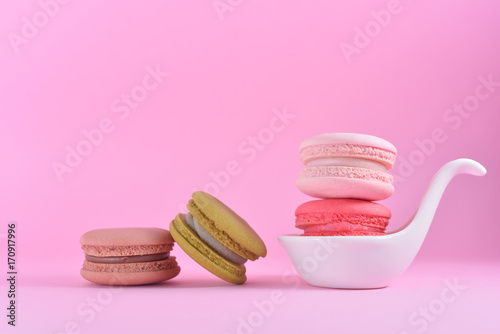 French Colourful Macarons In White Ceramic Cup On Pink Pastel