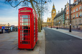 Fototapeta Big Ben - London, England - Traditional Old British red telephone box at Victoria Embankment with Big Ben at background