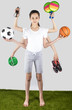 Smart girl in a white T-shirt with six hands standing on the green grass and holding sports equipment. Sport concept with many hand. Grey background.