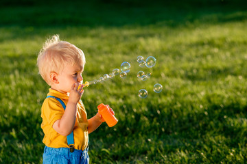 Wall Mural - One year old baby boy blowing soap bubbles