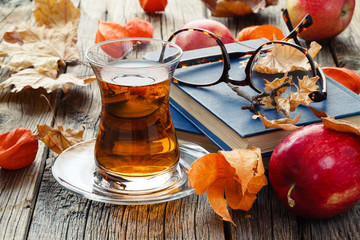 Canvas Print - Relax seasoning education. Fall leaf and book on wooden table