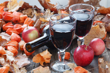 Wall Mural - Seasoning wine in glass. Red Leaf on table
