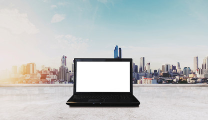 Canvas Print - Computer laptop on white table, with Bangkok city view in sunrise background. Clipping path computer screen