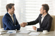 © fizkes - Happy smiling business partners shaking hands and congratulating each other after singing contract, successful negotiations, profitable partnership, trust between company leaders, conclusion agreement
