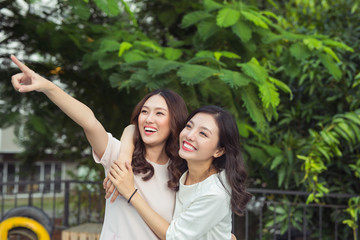 Wall Mural - Happy friends or teenage girls having fun outdoors