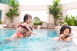 © makistock - Happy family in swimming pool. Summer holidays and vacation concept
