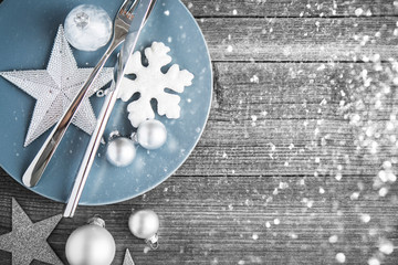 Wall Mural - christmas dinner plate decoration with xmas ornaments on old wood background. merry christmas greeti