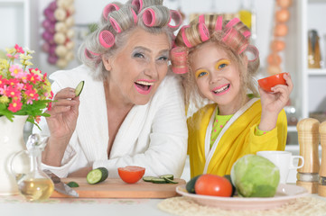 Senior woman and granddaughter at kitchen