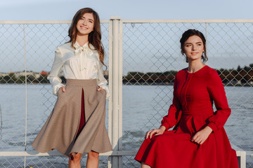 fashionable portrait of two girls in casual and red dress