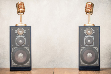 Wall Mural - retro stereo acoustic speakers system and golden microphones front concrete wall background. listeni
