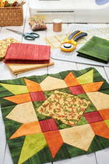 Patchwork orange-green block, quilting fabrics, sewing accessories