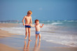 © Olesia Bilkei - two brothers, cute kids having fun on sandy beach