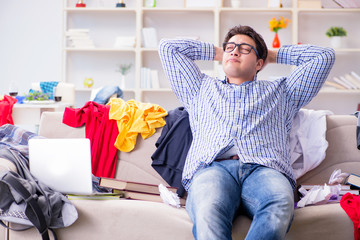 Wall Mural - Young man working studying in messy room