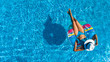 © Iuliia Sokolovska - Aerial top view of beautiful girl in swimming pool from above, relax swim on inflatable ring donut and has fun in water on family vacation