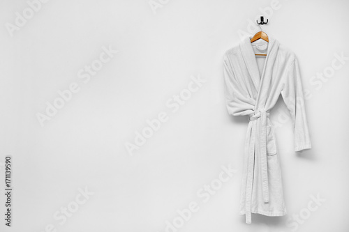 Fotomural Bathrobe hanging on white wall