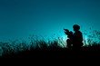 © kaninstudio - military soldier with weapons at sunset. shot, holding gun, colorful sky. military concept.