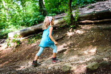 Children - twin girls are hiking in the mountains.