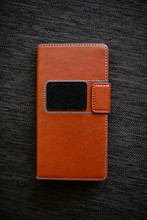 Leather Brown Phone Case On A Gray Background.