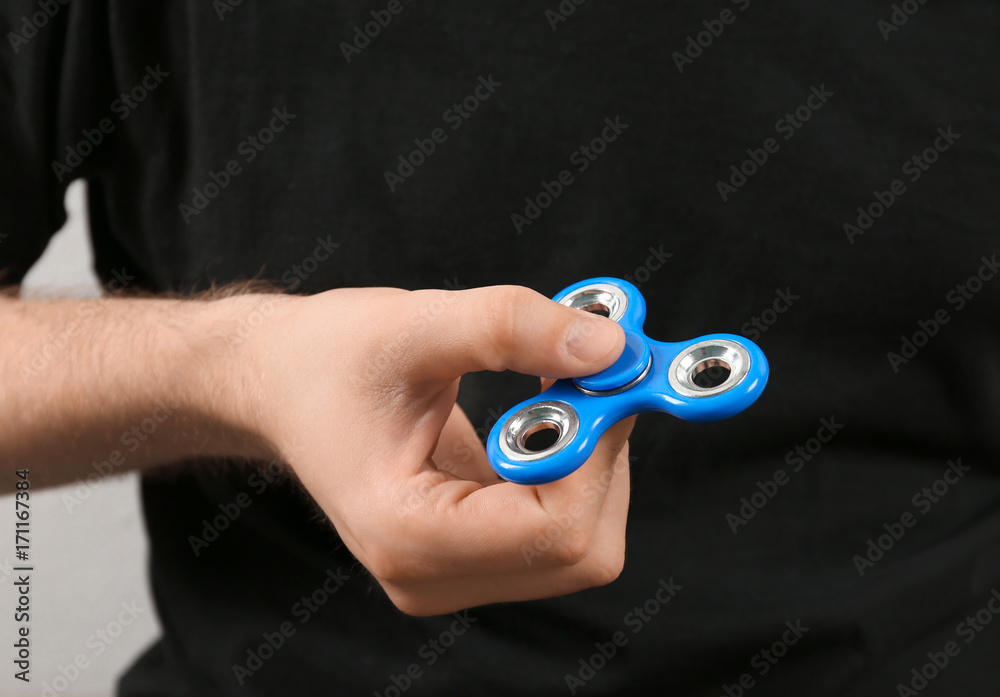 Man holding modern spinner, closeup