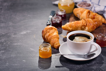 Wall Mural - cup of coffee and croissants with fruit jam