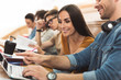 © Yakobchuk Olena - Happy students entertaining with gadget during lecture