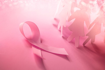 The Sweet pink ribbon shape with girl paper doll on pink background  for Breast Cancer Awareness symbol to promote  in october month campaign