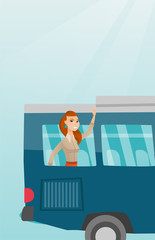 Poster - Young caucasian woman enjoying her trip by bus. Happy passenger waving hand from bus window. Cheerful tourist peeking out of bus window and waving hand. Vector cartoon illustration. Vertical layout.