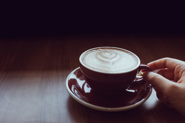 Hand holding coffee cup.