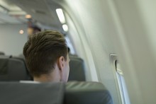 Male Passenger Travelling In An Aircraft