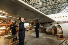 Aircraft Maintenance Engineers Examining Aircraft Wing 