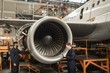 © Wavebreak Media - Aircraft maintenance engineers examining turbine engine of