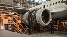 Aircraft Maintenance Engineers Examining Turbine Engine Of