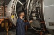 © Wavebreak Media - Male aircraft maintenance engineer examining turbine engine of