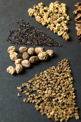 Wall Mural - Close-up, set of seeds on a black background, vertical.