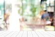 © mangpor2004 - Empty perspective white wood, tabletop, over blur restaurant with bokeh light background, food and product display montage background