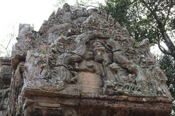 Khmer art in Angkor complex. A close-up image of a beautiful vintage relief composition on the wall of a temple in Cambodia.