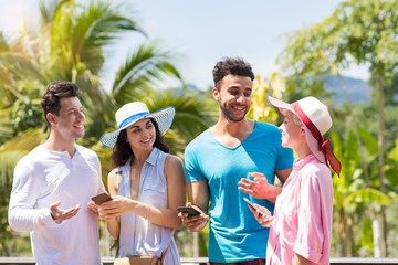 Sticker - Group Of Young People Talking Holding Cell Smarrtphones Over Green Tropical Forest Landscape Mix Race Men And Women Communicating Using Modern Telephones