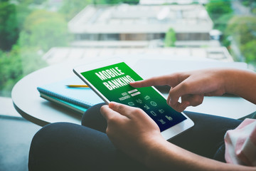 Poster - Close up hand of woman sitting and touch log in page of mobile banking on tablet computer in home,Financial (fintech) marketing concept, Vintage filter