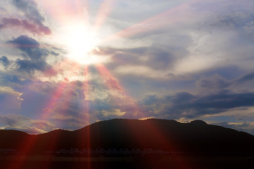 Wall Mural - The power of light in the evening before sunrise through the mountains.