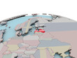 © harvepino - Political map of Latvia on globe with flag
