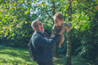 © LoloStock - Senior man lifting baby grandson in nature
